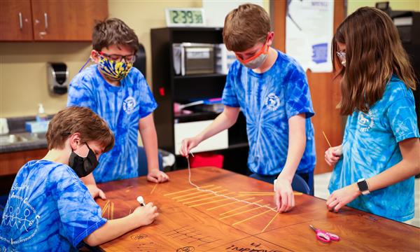 Students discuss their latest STEM challenge
